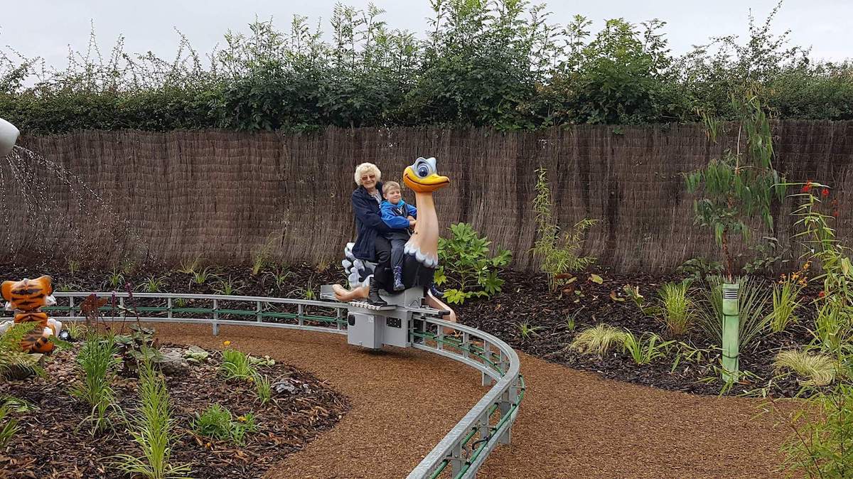 Audrey Rhodes rides on the Wild Ostrich Ride with her Grandson